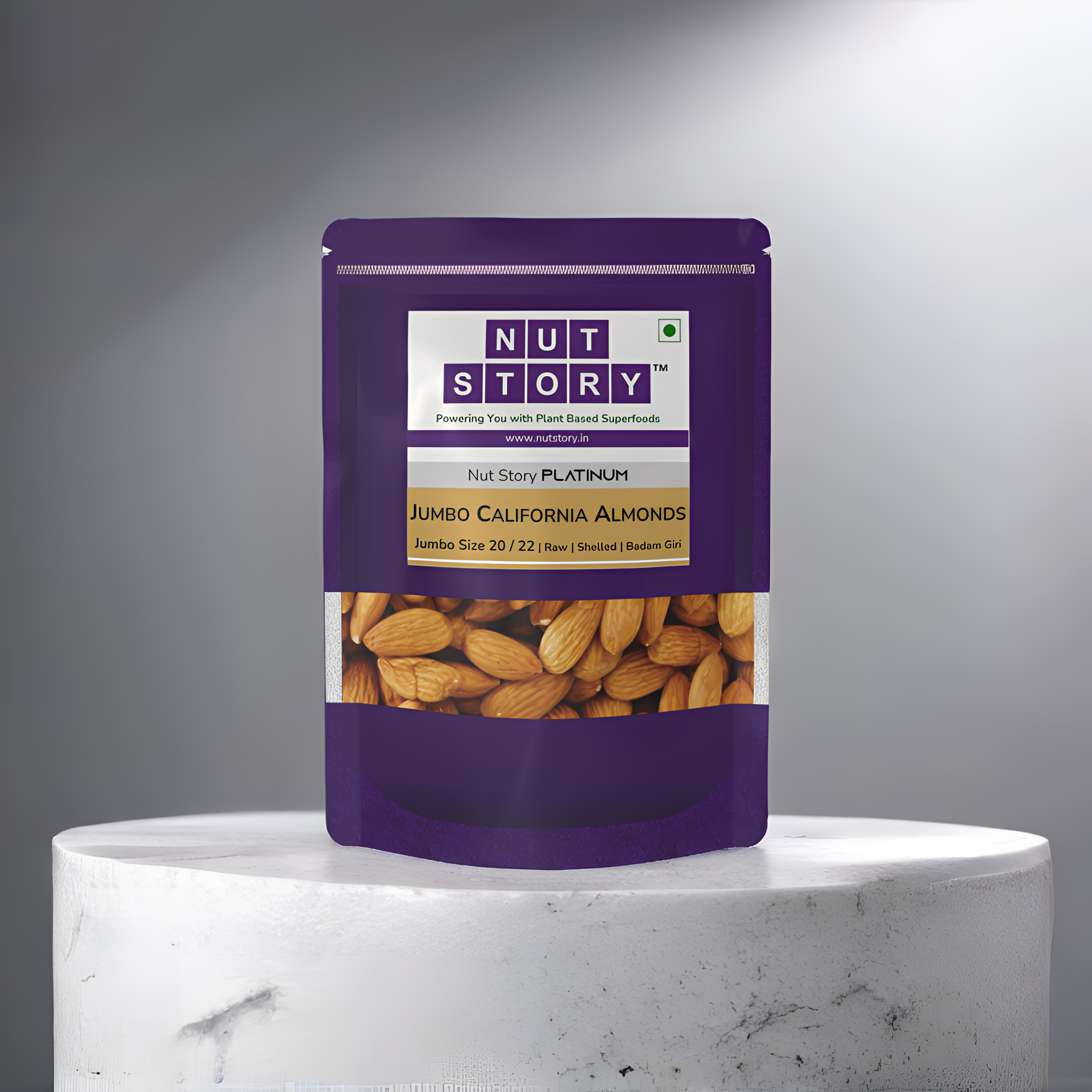 Purple package of Nut Story Platinum Jumbo California Almonds on a marble turntable with gray background