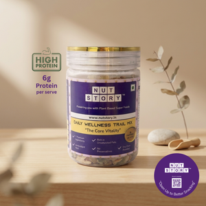 Jar of NutStory Daily Wellness Trail Mix with visible label on a cream background