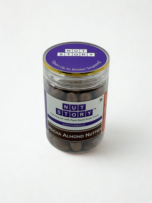Nut Story Mocha Almond Nutties jar alongside a cup of coffee — the perfect café-style indulgence